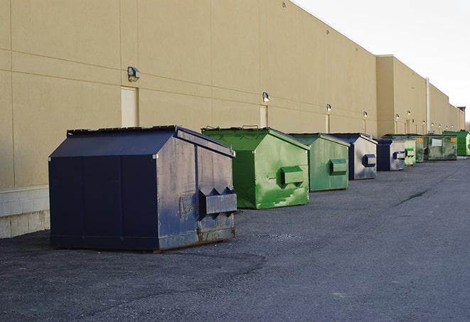 construction crew disposing of building materials in large bins in Elmont NY